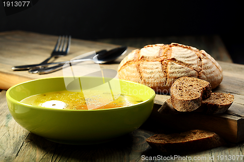 Image of Chicken soup with poached egg .