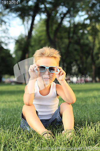 Image of Little boy sitting in the park