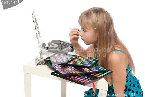 Image of Little girl paints his face makeup