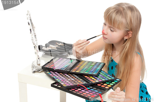 Image of Little girl paints his face makeup