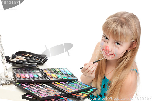 Image of Little girl paints his face makeup