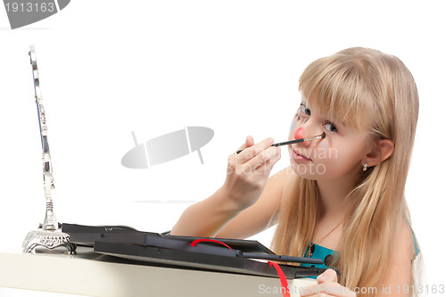 Image of Little girl paints his face makeup