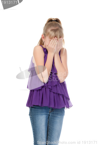 Image of Young girl shyly covered her face with her hands