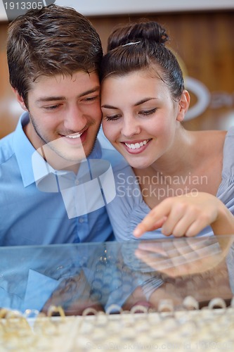 Image of happy young couple in jewelry store