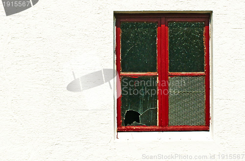 Image of old window with broken glass