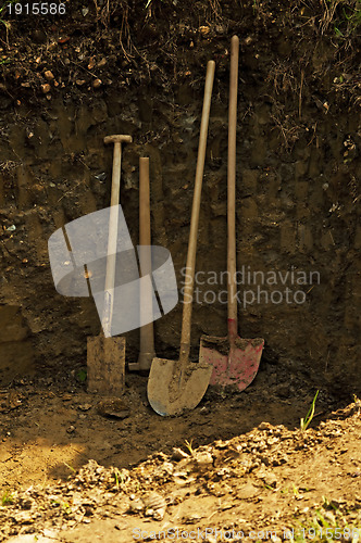 Image of hole with shovel,spade and hoe