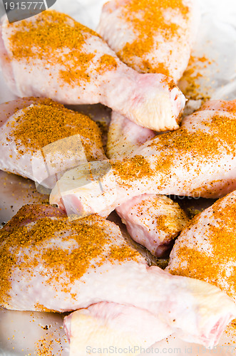 Image of  spiced chicken legs on the foil 