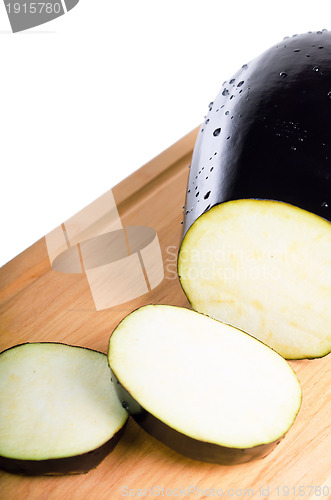Image of sliced Aubergine in kitchen Board isolated on white