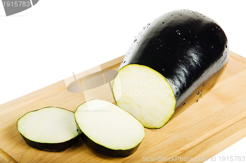 Image of sliced Aubergine in kitchen Board isolated on white