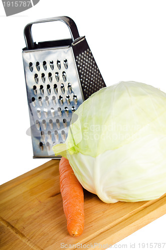 Image of Cabbage and carrots on a kitchen board, it is isolated on white