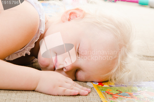 Image of little girl fell asleep after playing 