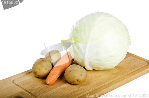 Image of Fresh vegetables on a kitchen Board isolated on white 