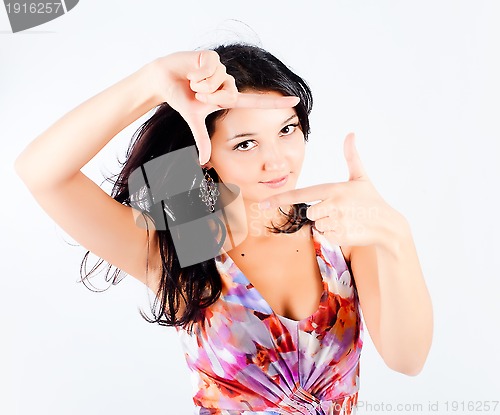 Image of Girl with frame gesture. Focus on fingers