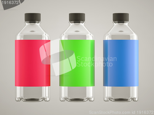 Image of Three bottles with colorful stickers over grey