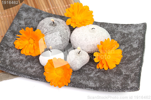 Image of candles and massage stones in a calm zen spa