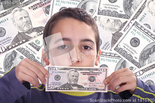 Image of boy with dolar bills, business studio photo