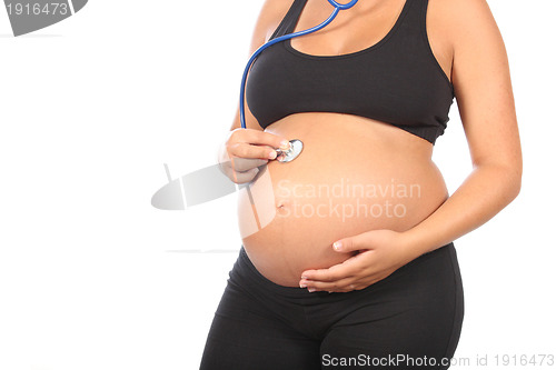 Image of beautiful pregnant woman being examined with a stethoscope