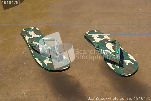 Image of beach slippers near the beach, summer, bathing