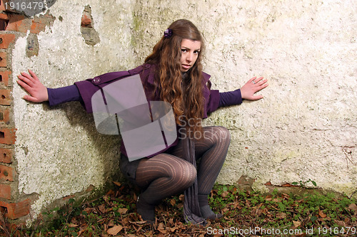 Image of  beautiful woman in an autumn park 