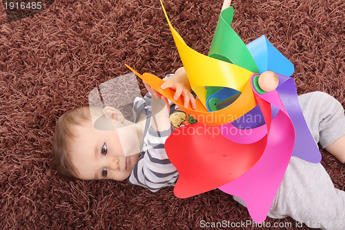 Image of beautiful and happy baby with wind mill