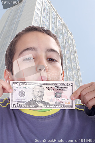 Image of boy blinded by money, studio photo