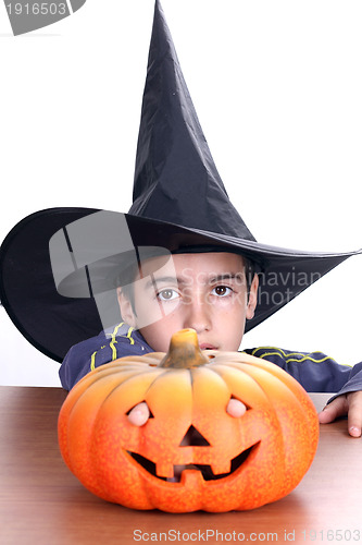 Image of big pumpkin with black witch wizard halloween (focus on the wiza