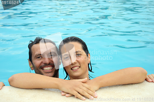 Image of Loving swimmingpool smiling couple