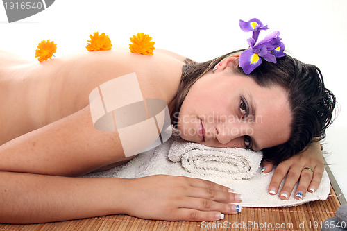 Image of attractive woman with hot stones treatment at a spa