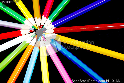 Image of Assortment of coloured pencils with shadow on white/back backgro