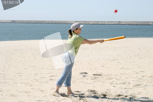 Image of playing baseball on the beach, sports photo