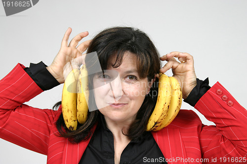 Image of beautiful woman eating banana, healthy food