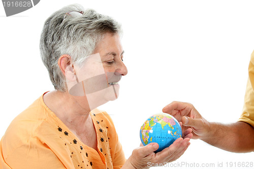 Image of mature woman holding earth globe, protection concept