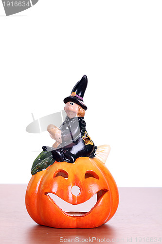 Image of big pumpkin with black witch wizard halloween