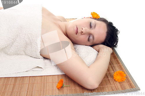Image of attractive woman with hot stones treatment at a spa