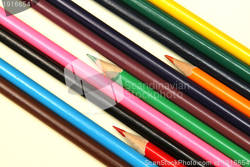 Image of Assortment of coloured pencils with shadow on white background