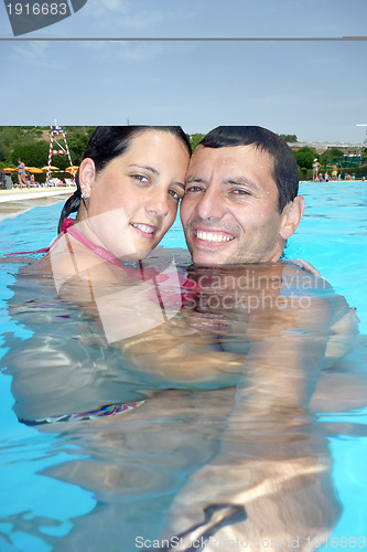 Image of Loving swimmingpool smiling couple