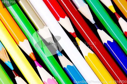 Image of Assortment of coloured pencils with shadow on white/back backgro