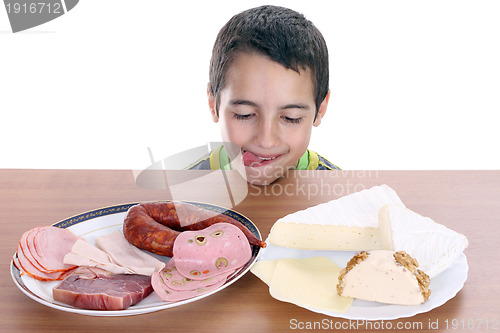 Image of hungry boy for cheese and sausage, food photo