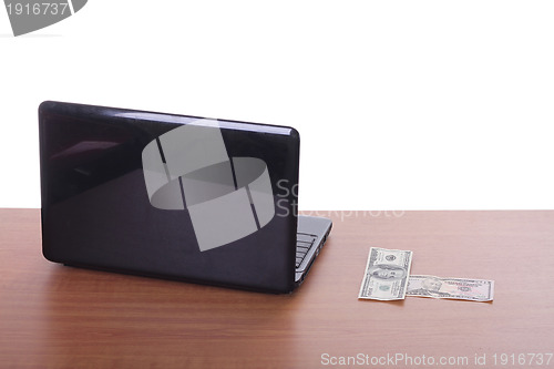 Image of money flying and pouring out from a notebook computer