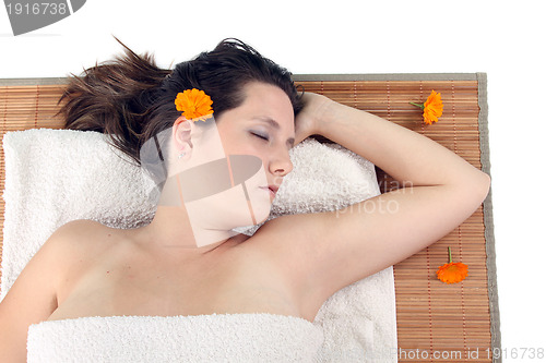 Image of attractive woman with hot stones treatment at a spa