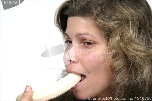 Image of beautiful woman eating banana, healthy food