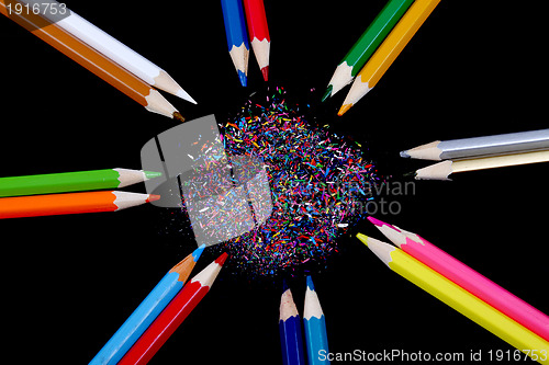 Image of Assortment of coloured pencils with shadow on white/back backgro