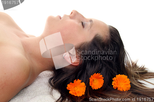 Image of attractive woman with hot stones treatment at a spa