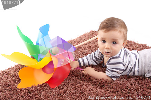 Image of beautiful and happy baby with wind mill