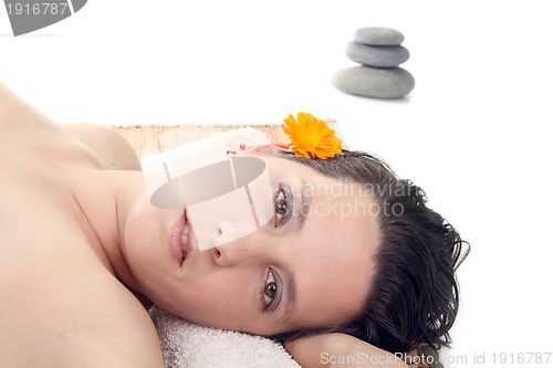 Image of attractive woman with hot stones treatment at a spa