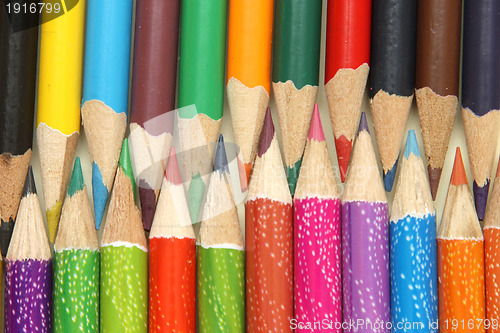 Image of Assortment of coloured pencils with shadow on white background