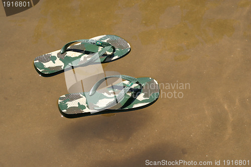 Image of beach slippers near the beach, summer, bathing
