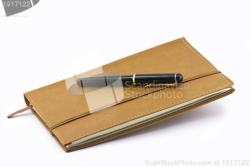 Image of Leather notebook and pen isolated 