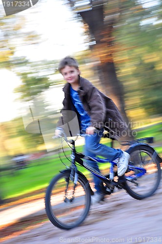 Image of happy boy riding bike