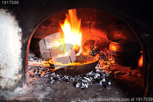 Image of cooking in an old fireplace